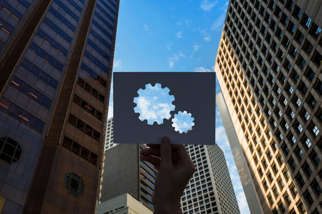 View of a tall building with a gear icon overlaid, symbolizing operations.
